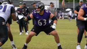 Danny Pinter, Baltimore Ravens center, blocking during practice before being carted off with a leg injury