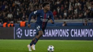 Ibrahim Mbaye in PSG jersey number 49 dribbling at pace