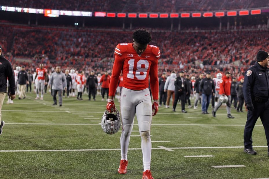 Dejected Ohio State Buckeyes player on the sideline after blowing a 20-point lead in a loss to Texas