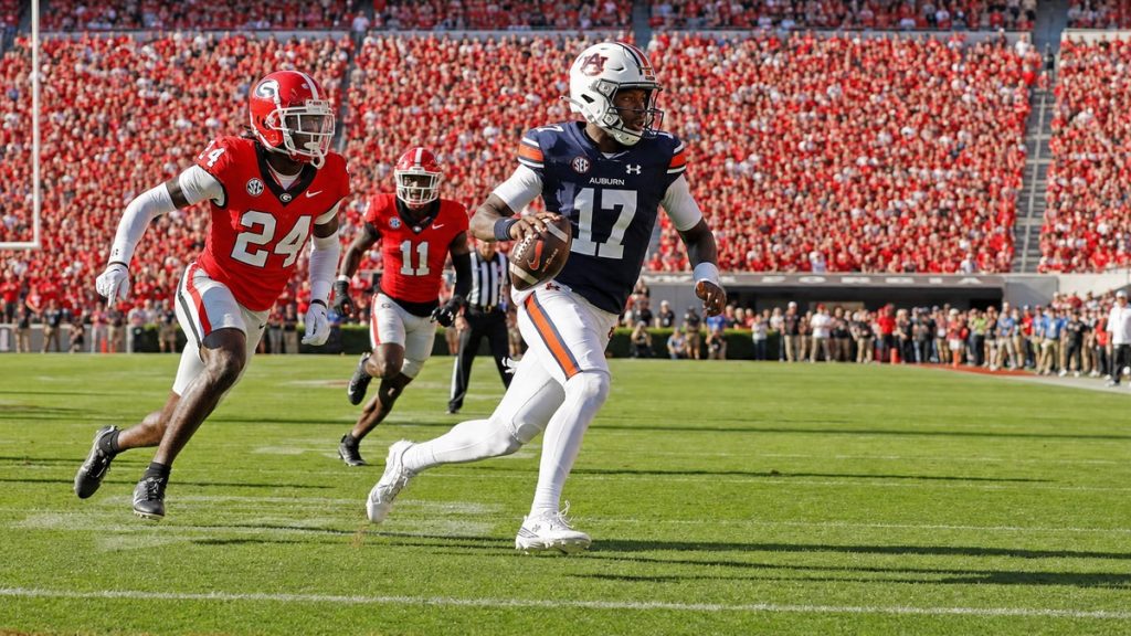 Auburn quarterback Byrum Brown running the ball against Georgia at Sanford Stadium