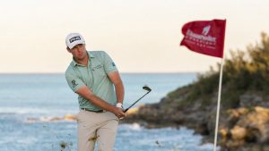 Seamus Power hitting an approach shot on a windy coastal golf course in Bermuda