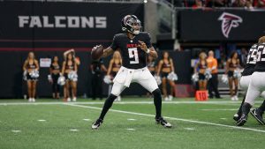 Atlanta Falcons quarterback Michael Penix Jr. dropping back to pass at Mercedes-Benz Stadium