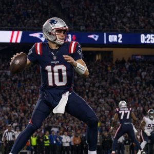Drake Maye of the New England Patriots dropping back to pass at Soldier Field