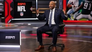 Sports debate show host at ESPN First Take desk discussing NFL news