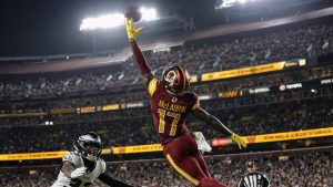 Terry McLaurin making a catch for the Washington Commanders in a night game